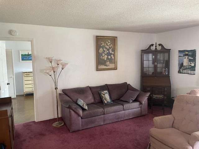 living area with a textured ceiling, carpet, and baseboards