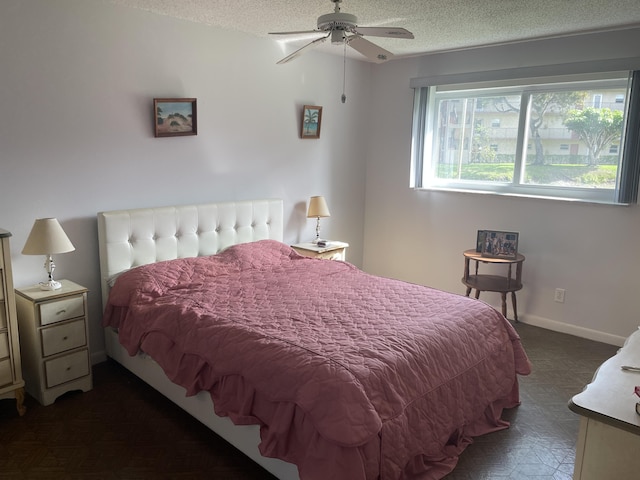 bedroom with a textured ceiling, baseboards, and tile patterned floors