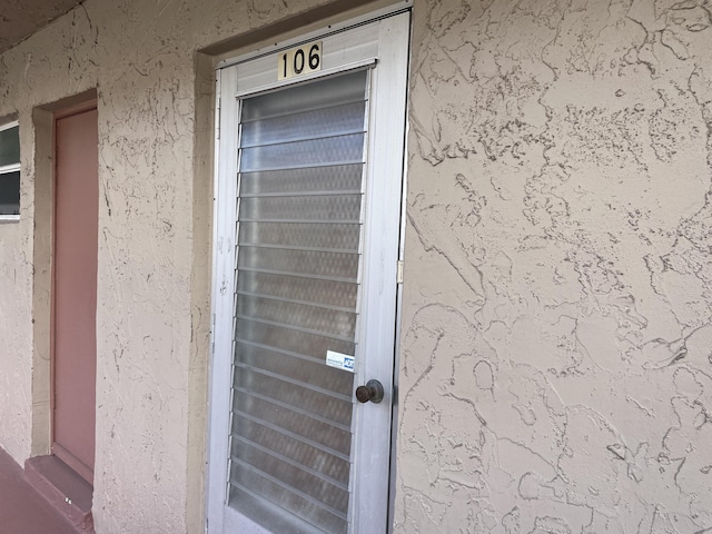 property entrance featuring stucco siding