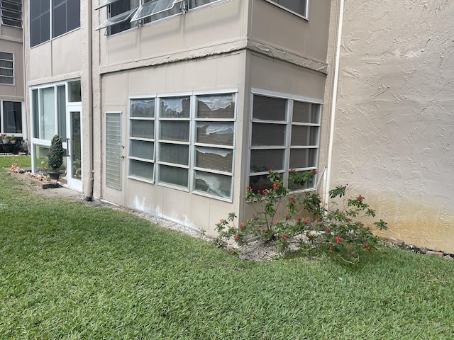 view of home's exterior featuring a yard and stucco siding