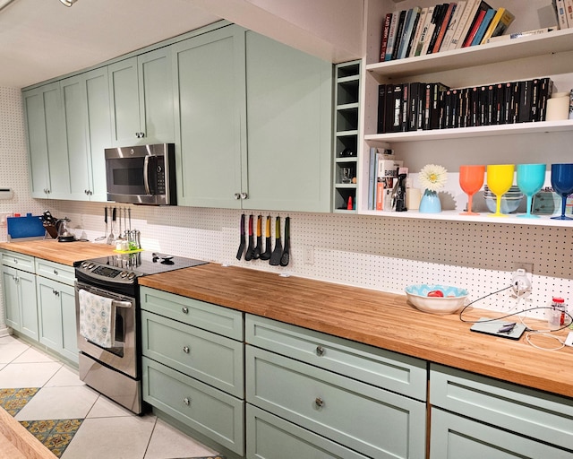 kitchen with appliances with stainless steel finishes, green cabinetry, and open shelves