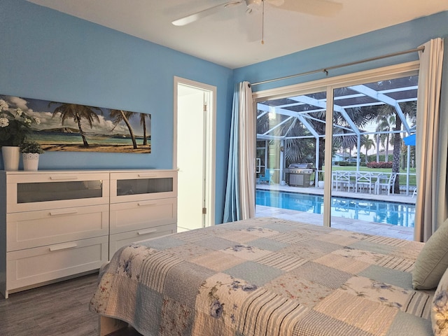 bedroom with a ceiling fan, access to outside, a sunroom, and dark wood-style flooring