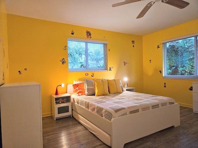 bedroom featuring dark wood-style floors, baseboards, and a ceiling fan