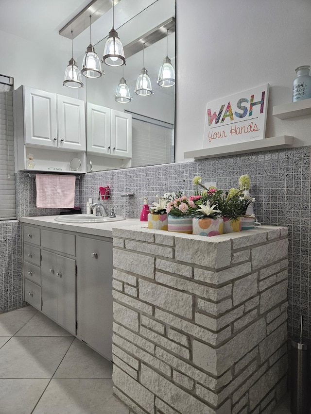 bathroom featuring tile patterned flooring, backsplash, and a sink