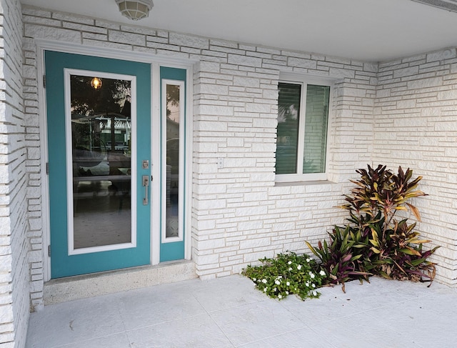 property entrance with brick siding