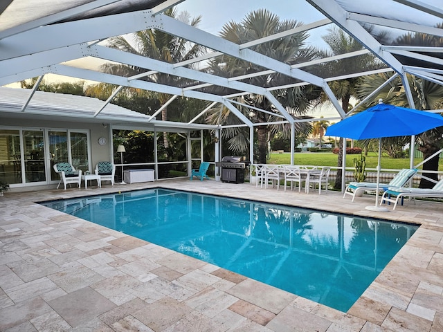 outdoor pool with a lanai and a patio