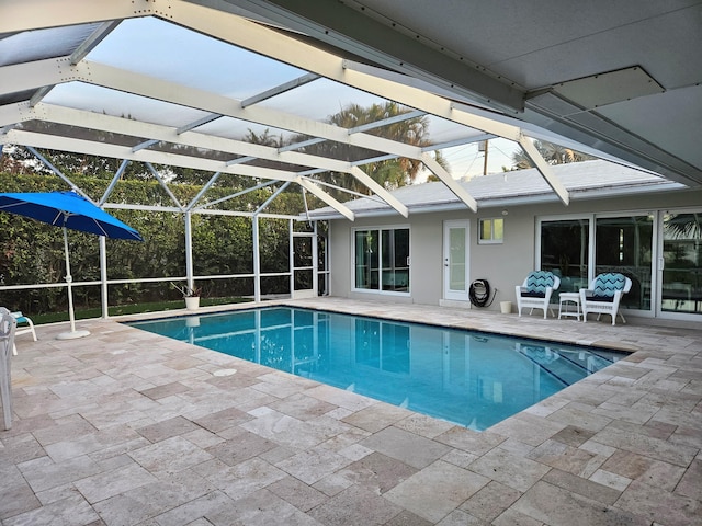 pool with glass enclosure and a patio