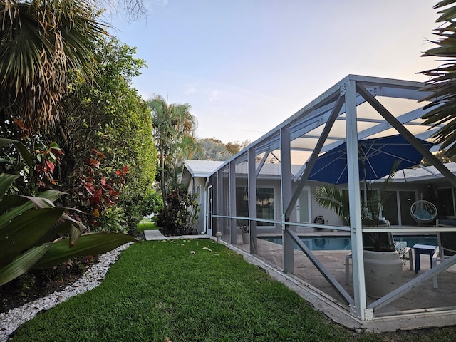 view of yard with a lanai and an outdoor pool