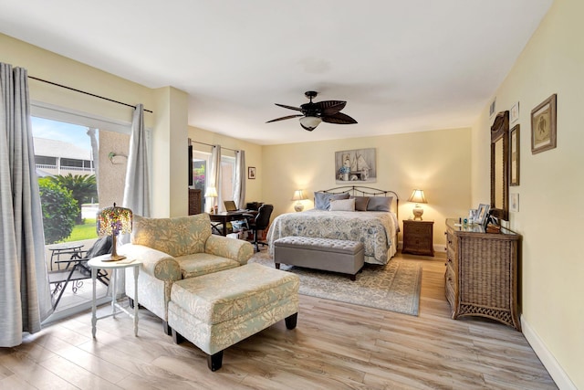 bedroom featuring ceiling fan, light wood finished floors, multiple windows, and access to exterior