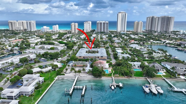 birds eye view of property with a view of city and a water view