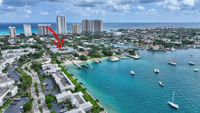 birds eye view of property featuring a water view and a view of city