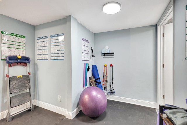 workout area featuring baseboards