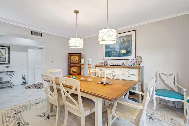 dining area with ornamental molding, light tile patterned flooring, and visible vents