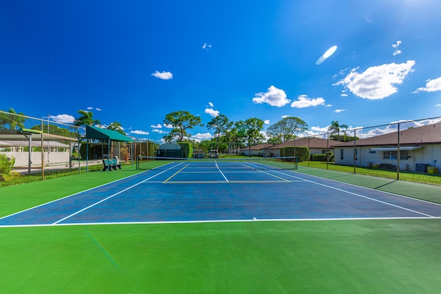 view of sport court featuring fence