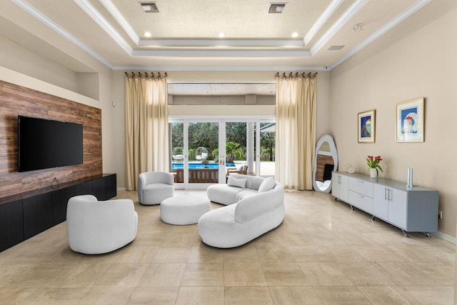 living room featuring a raised ceiling, visible vents, and french doors