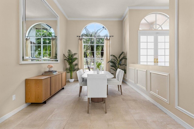 dining area with ornamental molding and baseboards