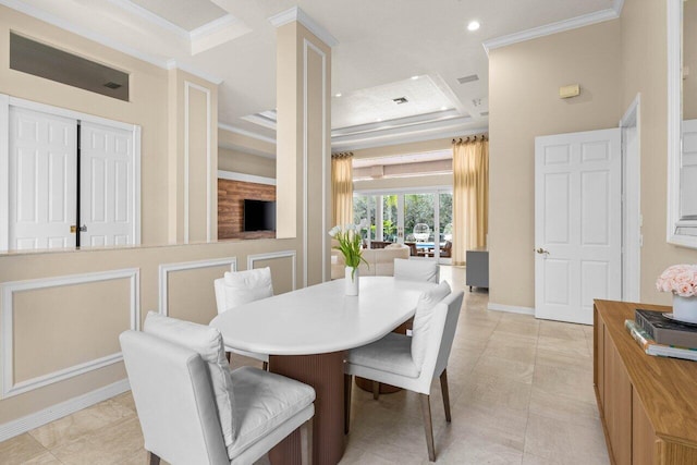 dining room featuring recessed lighting, baseboards, crown molding, and a tray ceiling