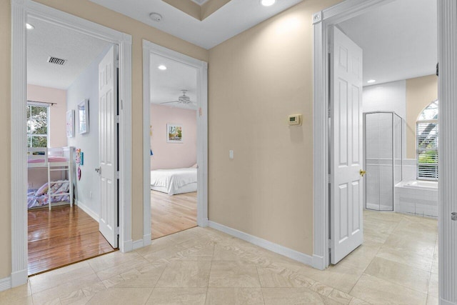 hallway with recessed lighting, visible vents, and baseboards