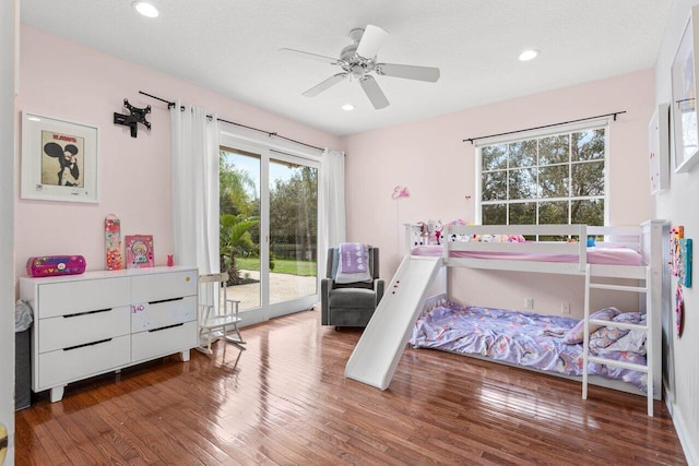 bedroom featuring a textured ceiling, access to outside, wood finished floors, and recessed lighting