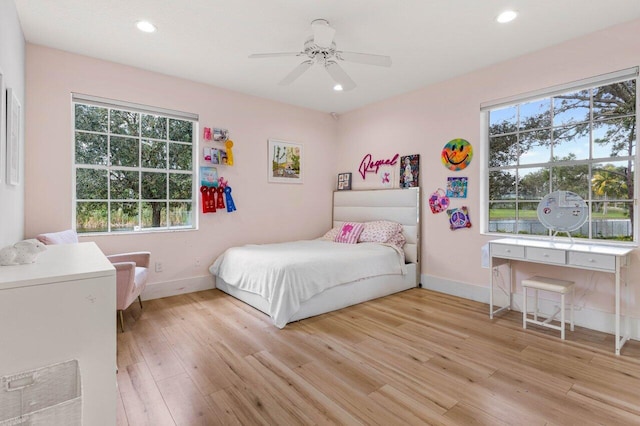 bedroom featuring baseboards, light wood-style flooring, and recessed lighting