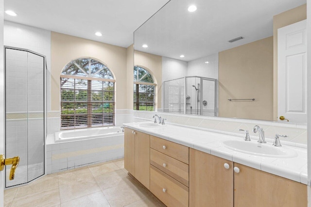 bathroom featuring a stall shower, visible vents, a sink, and tile patterned floors