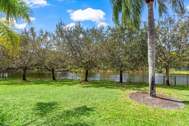 view of yard with a water view and fence