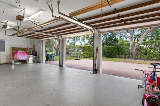 garage with a garage door opener and electric panel