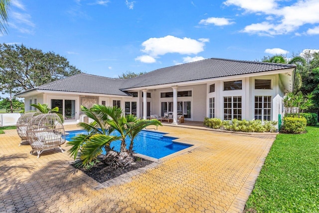 pool featuring a ceiling fan, french doors, and a patio area