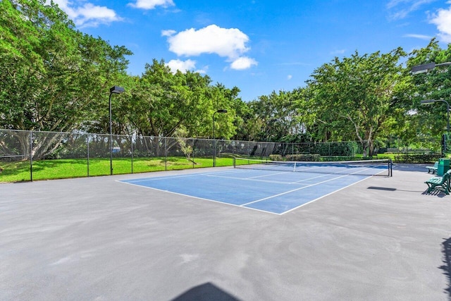 view of tennis court with fence