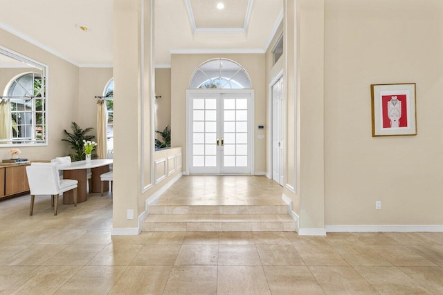 foyer entrance with french doors, a healthy amount of sunlight, and crown molding