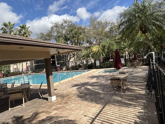 pool with a community hot tub and a patio area