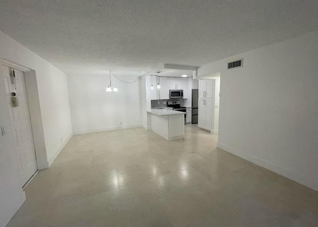 interior space with baseboards, a notable chandelier, visible vents, and a textured ceiling