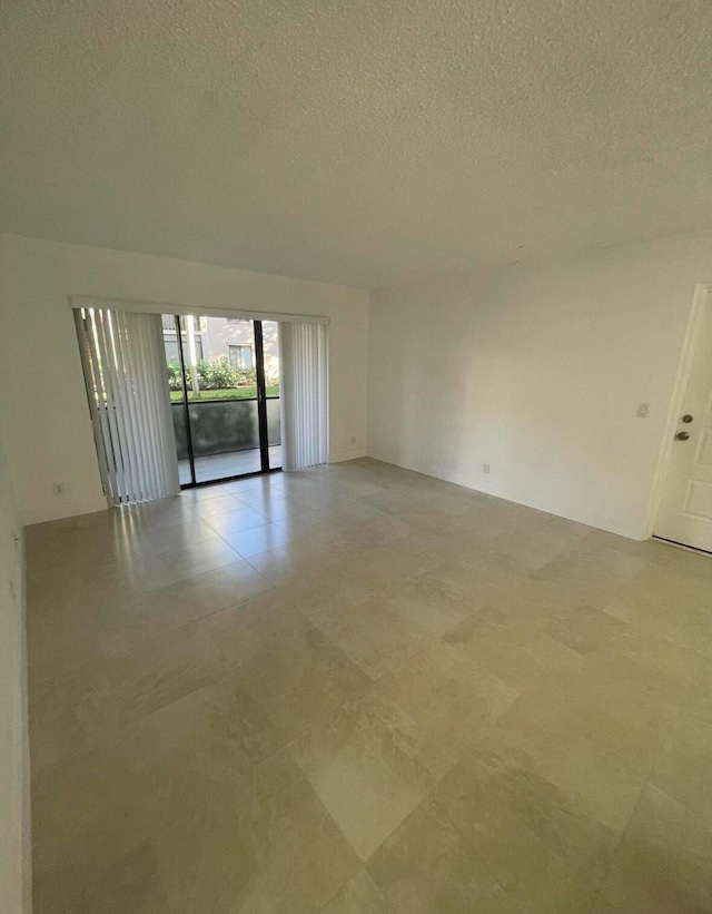 unfurnished room featuring a textured ceiling