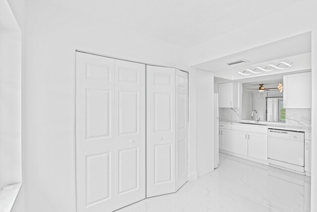 bathroom with marble finish floor, a closet, vanity, and visible vents