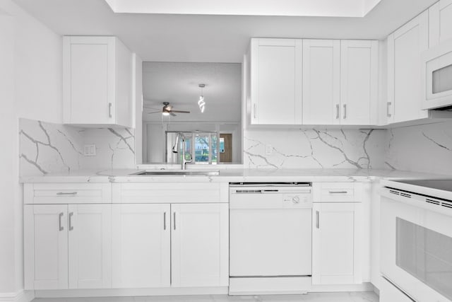 kitchen featuring ceiling fan, white appliances, a sink, and white cabinets