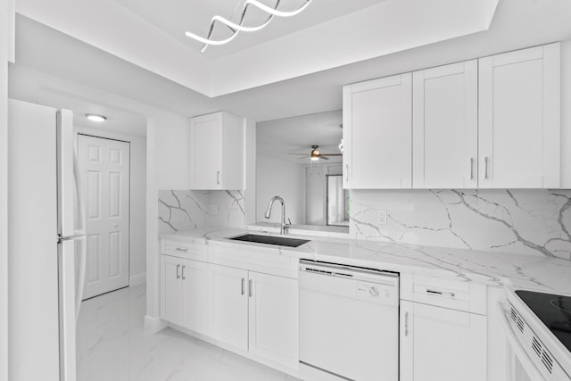 kitchen with white appliances, a sink, white cabinets, marble finish floor, and tasteful backsplash