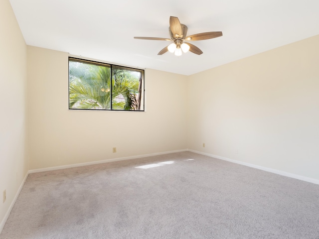 spare room with baseboards, carpet floors, and ceiling fan