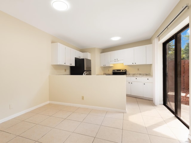 kitchen with baseboards, under cabinet range hood, light countertops, appliances with stainless steel finishes, and a peninsula