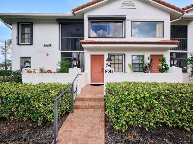 view of front of home with stucco siding and a tiled roof