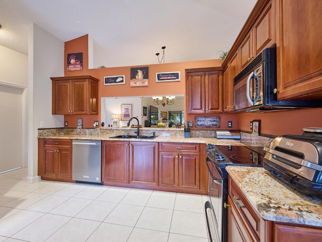 kitchen featuring appliances with stainless steel finishes, brown cabinetry, light tile patterned flooring, a sink, and a chandelier