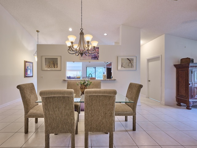 dining room with light tile patterned floors, a textured ceiling, baseboards, and an inviting chandelier