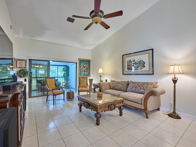 living area featuring light tile patterned floors, visible vents, baseboards, a ceiling fan, and high vaulted ceiling