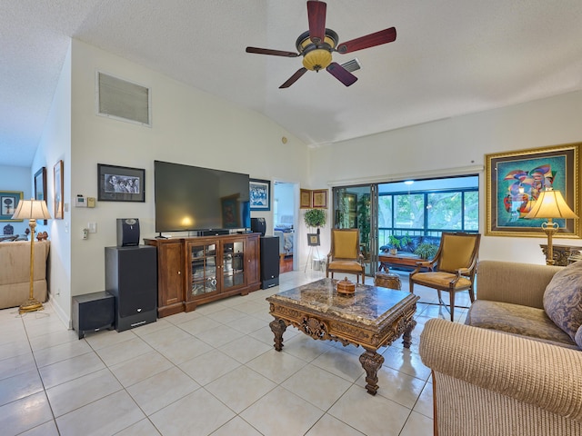 living area featuring light tile patterned floors, a textured ceiling, visible vents, a ceiling fan, and vaulted ceiling