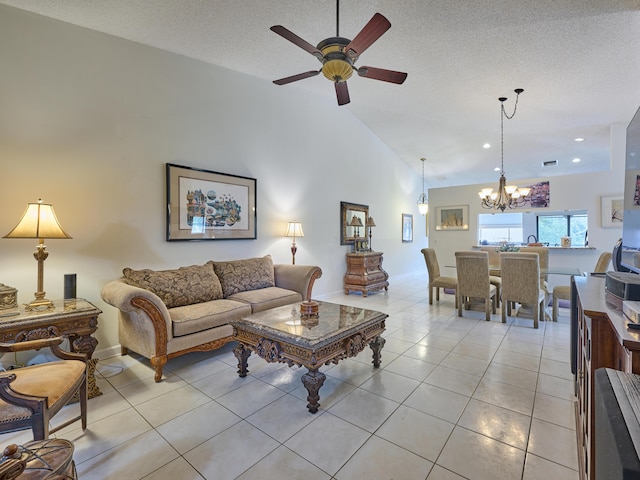 living area featuring light tile patterned floors, baseboards, a textured ceiling, high vaulted ceiling, and ceiling fan with notable chandelier