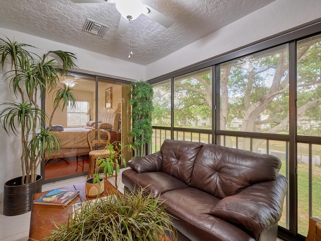 sunroom featuring visible vents and a ceiling fan