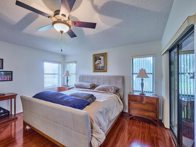 bedroom featuring a textured ceiling, ceiling fan, dark wood finished floors, and baseboards