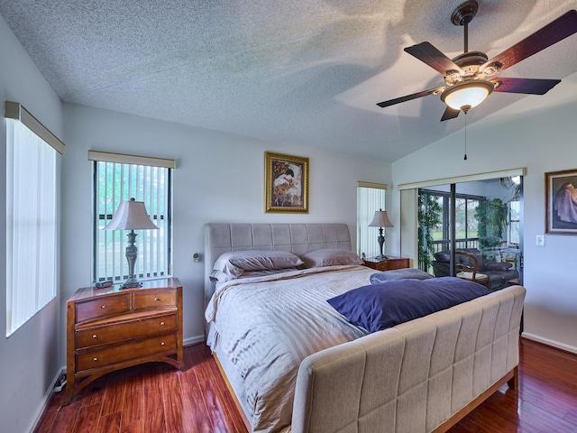 bedroom with a textured ceiling, wood finished floors, baseboards, vaulted ceiling, and access to exterior