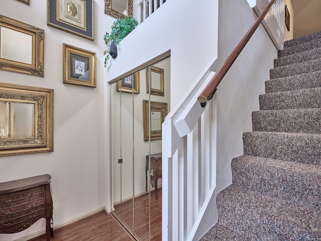 stairs featuring baseboards and wood finished floors