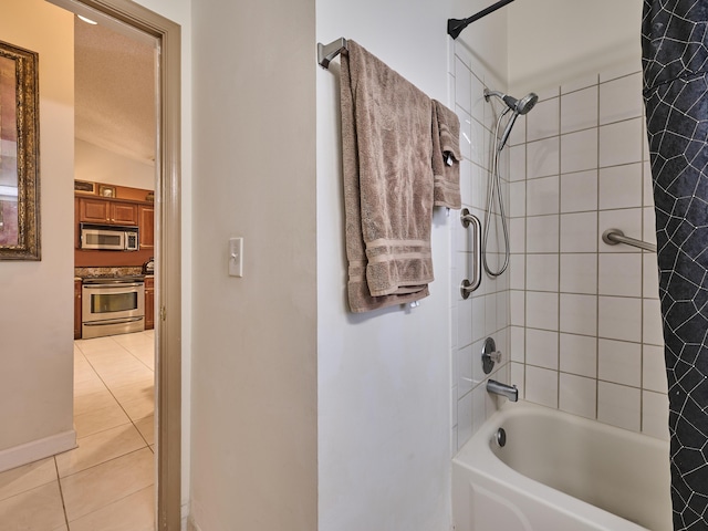 bathroom with tile patterned flooring and washtub / shower combination