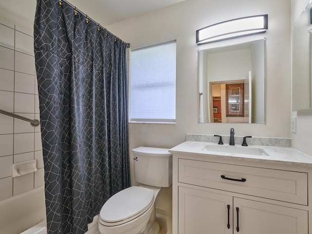 bathroom featuring toilet, shower / bath combo with shower curtain, and vanity